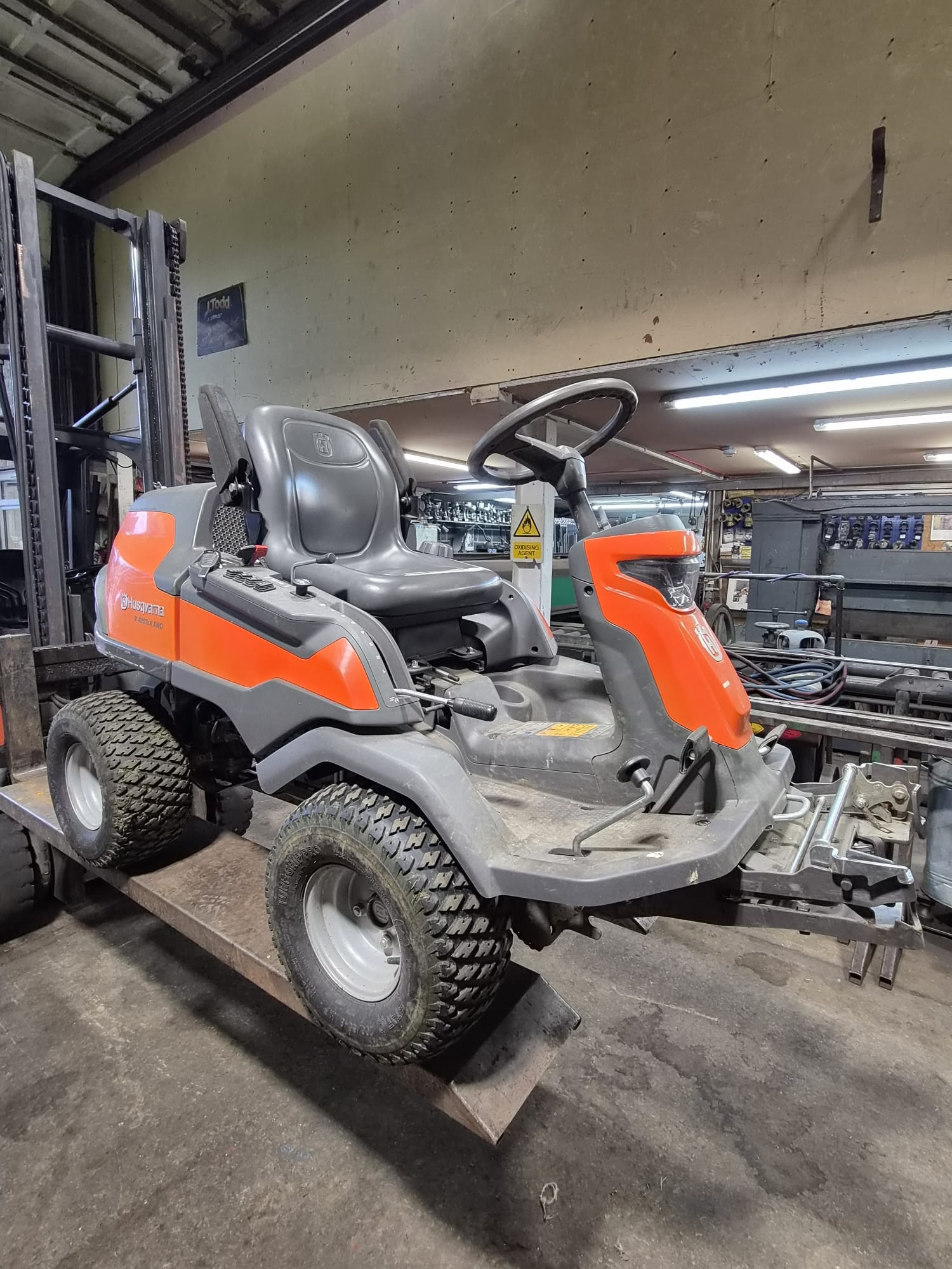 Husqvarna ride-on mower on service ramps